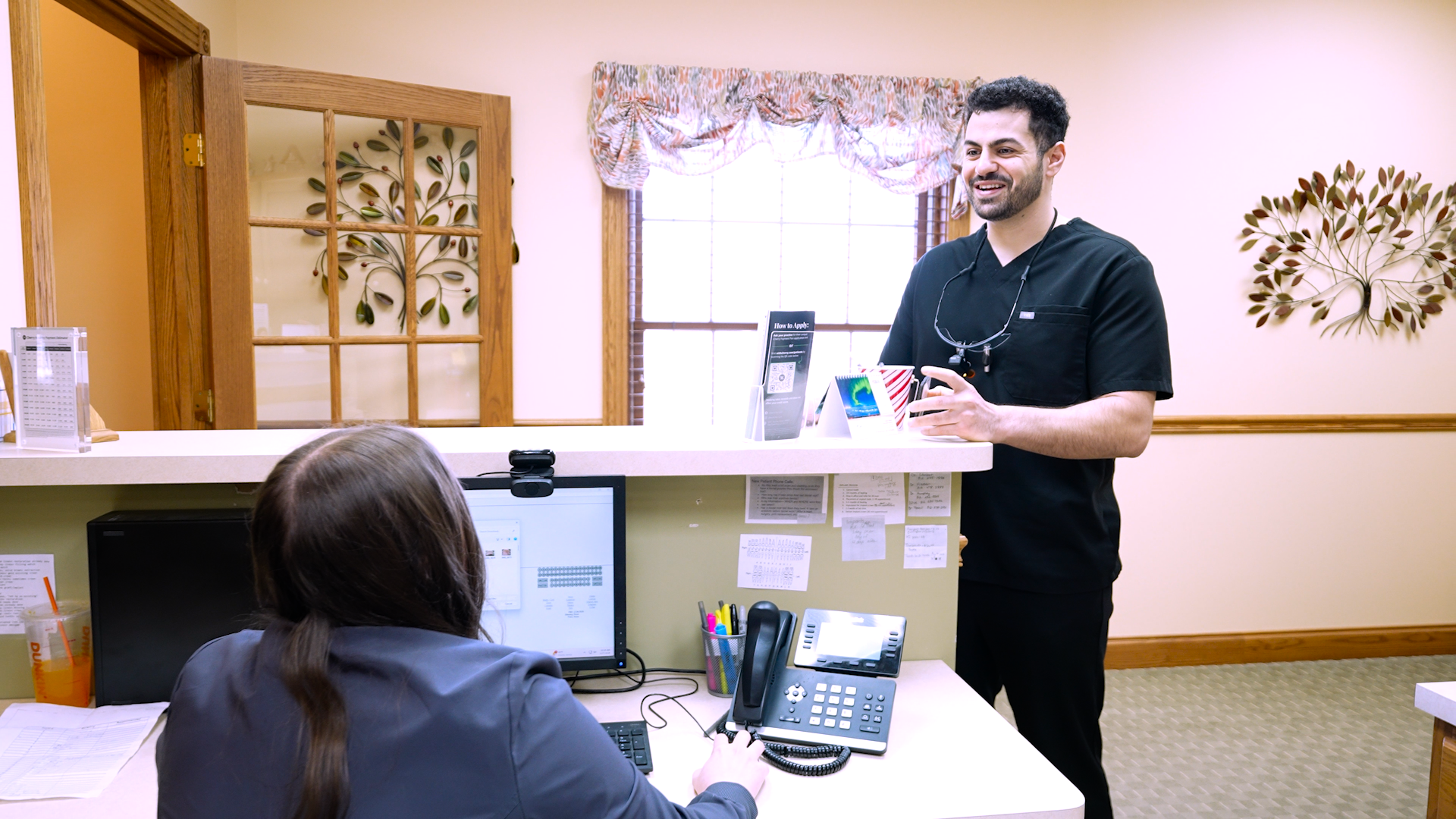 Dr. Sam Hazime speaking with a colleague at Friendly Family Dentistry